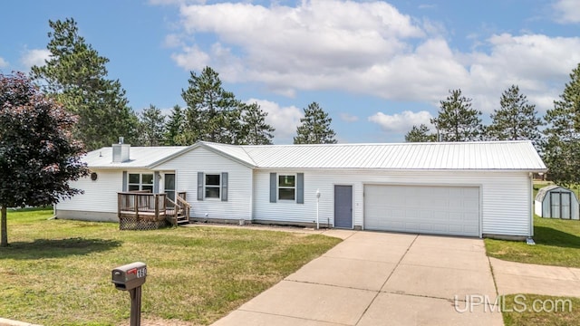 160 N Pyle Dr, Kingsford, MI 49802 - ranch-style home featuring a storage shed, concrete driveway, a garage, and a metal roof