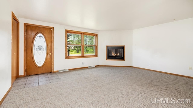 160 N Pyle Dr, Kingsford, MI 49802 - foyer featuring light colored carpet and a glass covered fireplace