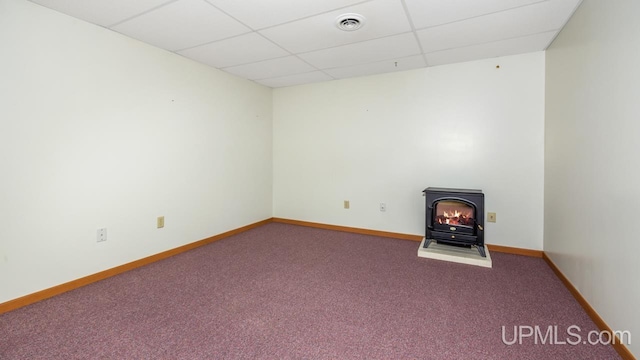 160 N Pyle Dr, Kingsford, MI 49802 - carpeted empty room with a drop ceiling and a wood stove