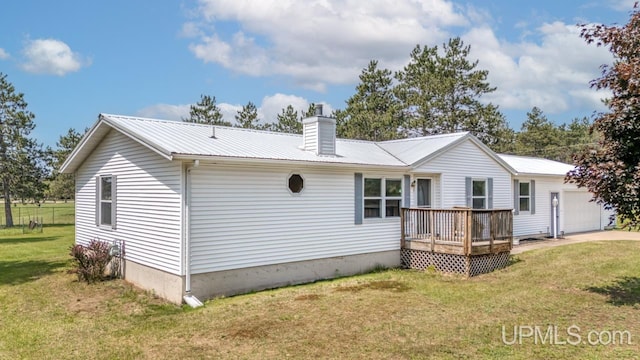 160 N Pyle Dr, Kingsford, MI 49802 - back of property featuring a metal roof, a chimney, a lawn, and a deck