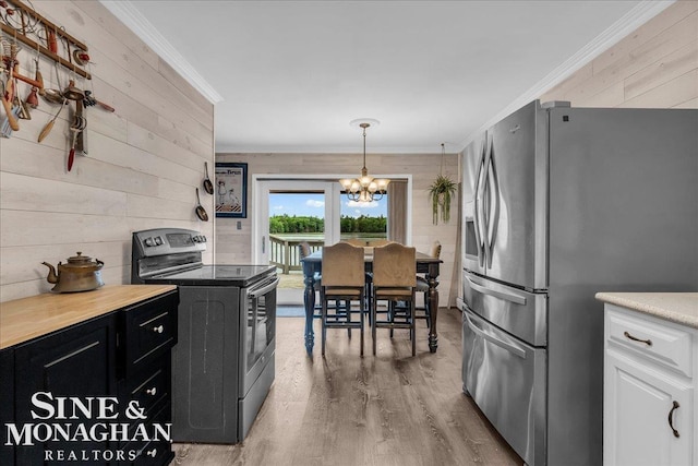 2727 Horseshoe Lake Rd, West Branch, MI 48661 - kitchen featuring stainless steel appliances, a chandelier, ornamental molding, light wood-type flooring, and wooden walls