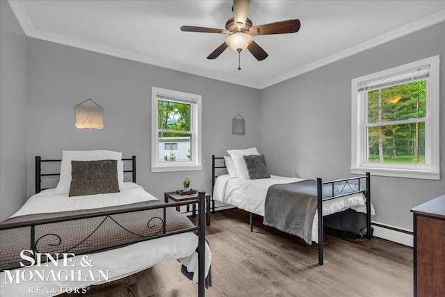2727 Horseshoe Lake Rd, West Branch, MI 48661 - bedroom with a baseboard heating unit, wood finished floors, crown molding, and ceiling fan
