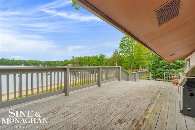 2727 Horseshoe Lake Rd, West Branch, MI 48661 - wooden terrace with area for grilling and view of scattered trees