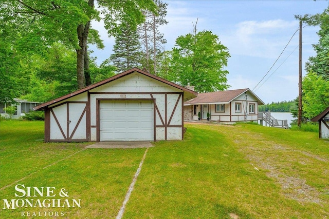 2727 Horseshoe Lake Rd, West Branch, MI 48661 - view of front of property featuring a detached garage, a front yard, driveway, and an outdoor structure