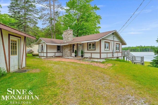 2727 Horseshoe Lake Rd, West Branch, MI 48661 - ranch-style home featuring a chimney, a front lawn, and a porch