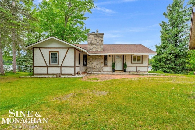 2727 Horseshoe Lake Rd, West Branch, MI 48661 - view of front of house featuring a chimney, a front lawn, and covered porch