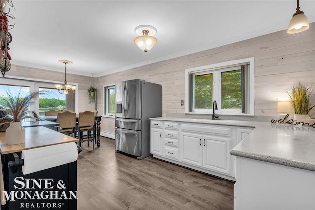2727 Horseshoe Lake Rd, West Branch, MI 48661 - kitchen featuring stainless steel refrigerator with ice dispenser, a chandelier, white cabinets, crown molding, and decorative light fixtures