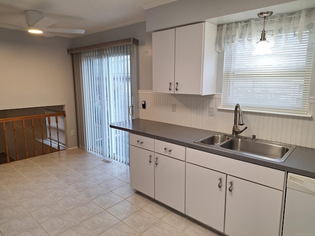 4130 Elmhurst Rd, Waterford, MI 48328 - kitchen with white dishwasher, dark countertops, ceiling fan, healthy amount of natural light, and a wainscoted wall