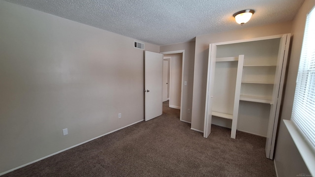 4130 Elmhurst Rd, Waterford, MI 48328 - unfurnished bedroom featuring a textured ceiling, carpet, a closet, and multiple windows