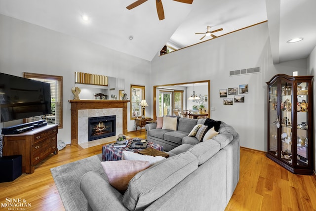 23875 Settlers Dr, Macomb Twp, MI 48042 - living area featuring a ceiling fan, a fireplace, high vaulted ceiling, and light wood-style floors
