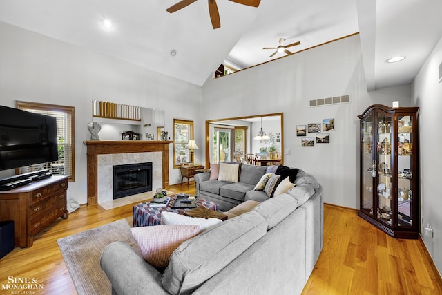 23875 Settlers Dr, Macomb Twp, MI 48042 - living room featuring a ceiling fan, a fireplace, high vaulted ceiling, light wood-type flooring, and recessed lighting