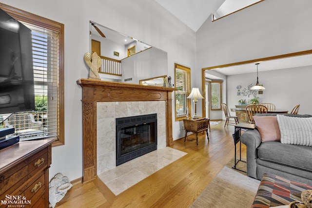 23875 Settlers Dr, Macomb Twp, MI 48042 - living area featuring light wood-type flooring, healthy amount of natural light, and lofted ceiling