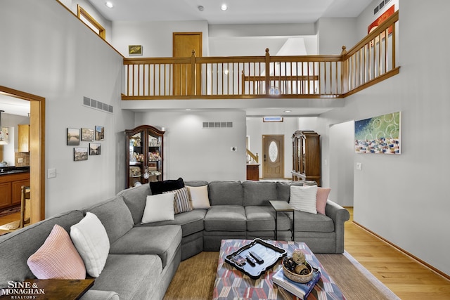 23875 Settlers Dr, Macomb Twp, MI 48042 - living area with a high ceiling, wood finished floors, and recessed lighting