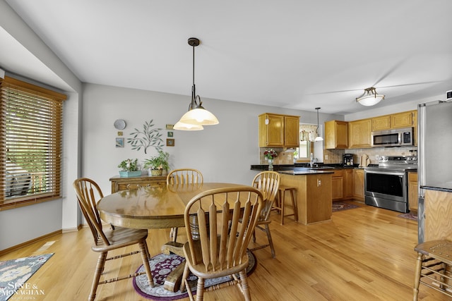 23875 Settlers Dr, Macomb Twp, MI 48042 - dining room with light wood finished floors and baseboards