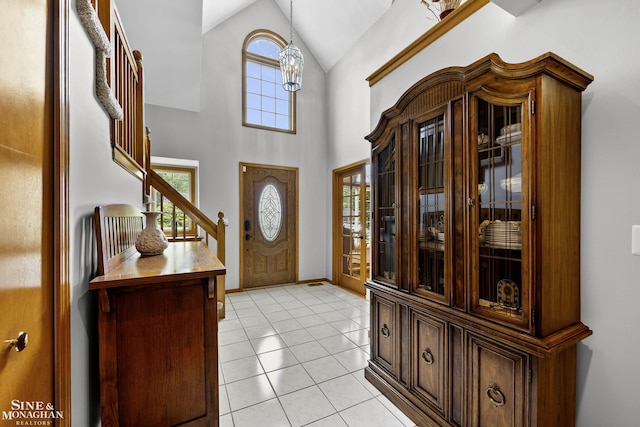 23875 Settlers Dr, Macomb Twp, MI 48042 - entryway featuring light tile patterned flooring, high vaulted ceiling, and stairs