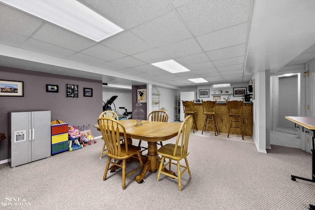 23875 Settlers Dr, Macomb Twp, MI 48042 - dining space featuring carpet floors, a paneled ceiling, and bar