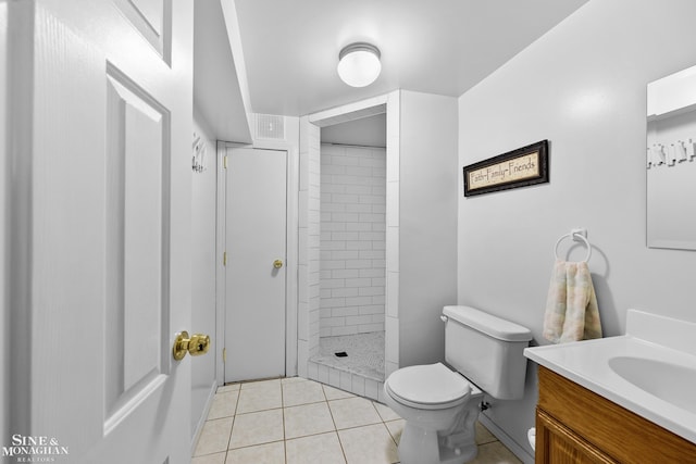 23875 Settlers Dr, Macomb Twp, MI 48042 - bathroom featuring vanity, a tile shower, and tile patterned floors