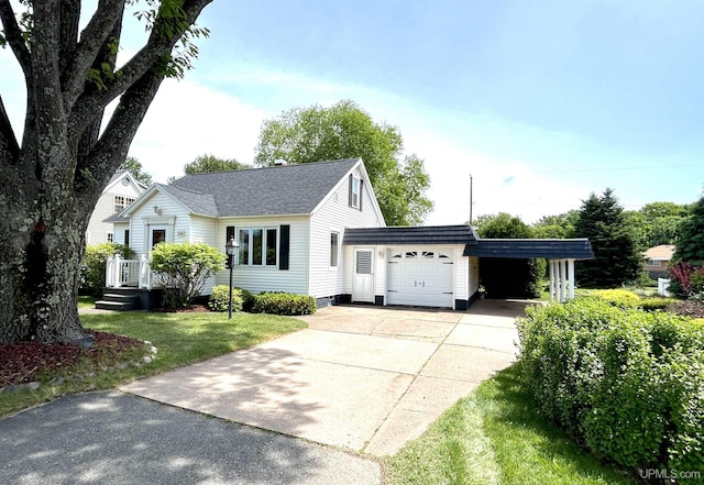 2010 Deer Lake Ave, Ishpeming, MI 49849 - view of front of house featuring driveway, a front yard, an attached garage, a shingled roof, and a carport