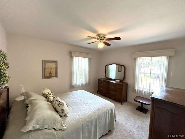 2010 Deer Lake Ave, Ishpeming, MI 49849 - bedroom featuring multiple windows, light colored carpet, and ceiling fan