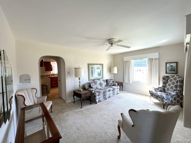 2010 Deer Lake Ave, Ishpeming, MI 49849 - carpeted living room with arched walkways and a ceiling fan