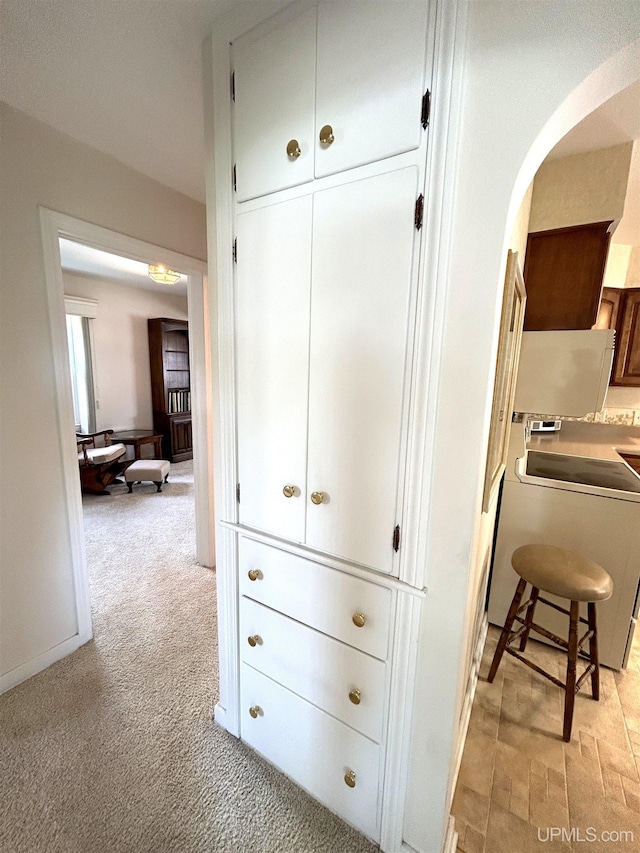 2010 Deer Lake Ave, Ishpeming, MI 49849 - kitchen view of arched walkways, white cabinets, range, and light carpet