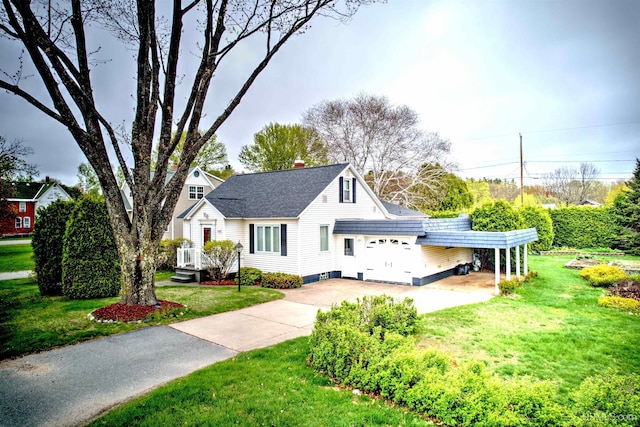 2010 Deer Lake Ave, Ishpeming, MI 49849 - view of front of home with concrete driveway, a front yard, a chimney, and a carport