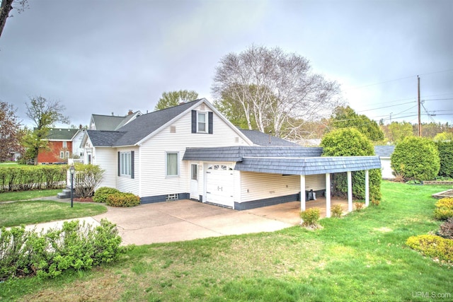 2010 Deer Lake Ave, Ishpeming, MI 49849 - view of front of house featuring an attached garage, a front yard, and driveway