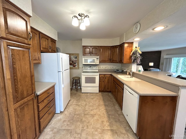 2010 Deer Lake Ave, Ishpeming, MI 49849 - kitchen with white appliances, a peninsula, light countertops, and stone finish flooring