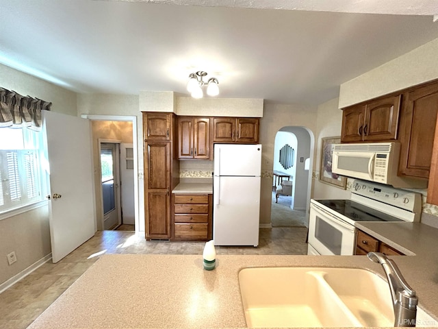 2010 Deer Lake Ave, Ishpeming, MI 49849 - kitchen with white appliances, arched walkways, and light countertops