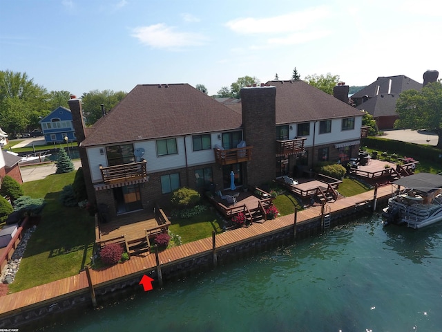 131 Cherryl Ln Unit 4, Algonac, MI 48001 - back of house with a balcony, a chimney, a residential view, a patio, and a water view
