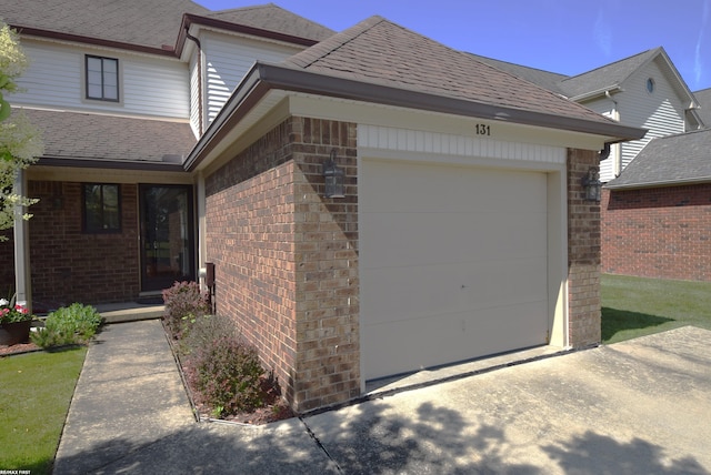 131 Cherryl Ln Unit 4, Algonac, MI 48001 - view of front of property featuring brick siding, an attached garage, driveway, and roof with shingles
