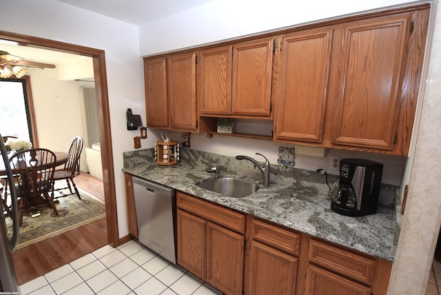 131 Cherryl Ln Unit 4, Algonac, MI 48001 - kitchen featuring stainless steel dishwasher, brown cabinets, light tile patterned floors, and stone counters