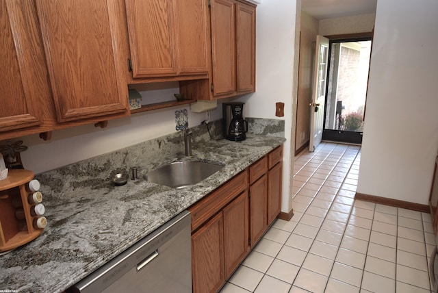 131 Cherryl Ln Unit 4, Algonac, MI 48001 - kitchen with stainless steel dishwasher, light tile patterned floors, brown cabinetry, and light stone counters