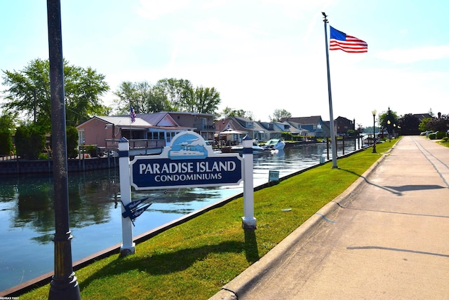 131 Cherryl Ln Unit 4, Algonac, MI 48001 - dock area with a residential view, a water view, and a lawn