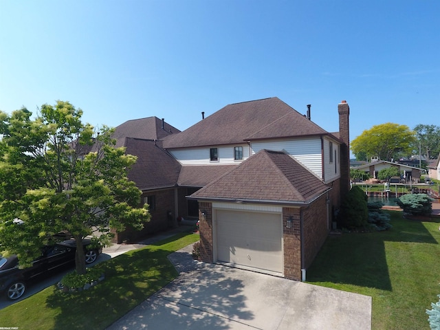 131 Cherryl Ln Unit 4, Algonac, MI 48001 - traditional home with brick siding, driveway, a front yard, a garage, and a shingled roof