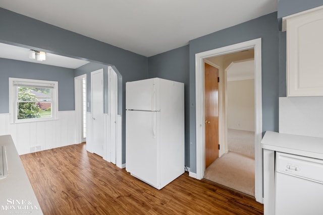 1284 Brys Dr, Grosse Pointe Woods, MI 48236 - kitchen featuring white appliances, wood finished floors, white cabinetry, light countertops, and wainscoting