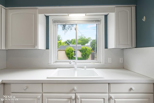 1284 Brys Dr, Grosse Pointe Woods, MI 48236 - kitchen with light countertops and white cabinetry