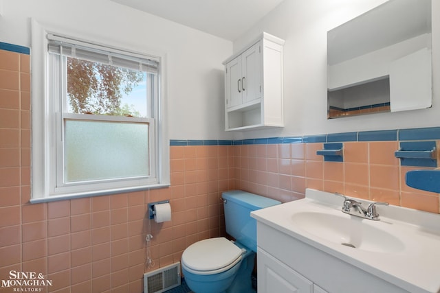 1284 Brys Dr, Grosse Pointe Woods, MI 48236 - half bathroom featuring vanity, a wainscoted wall, and tile walls