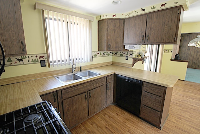 48501 E Ranch Dr, Chesterfield Twp, MI 48051 - kitchen with dishwasher, a peninsula, light countertops, dark brown cabinetry, and light wood-style flooring