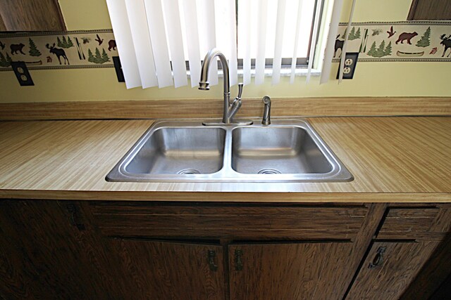 48501 E Ranch Dr, Chesterfield Twp, MI 48051 - kitchen view of a sink and dark brown cabinetry