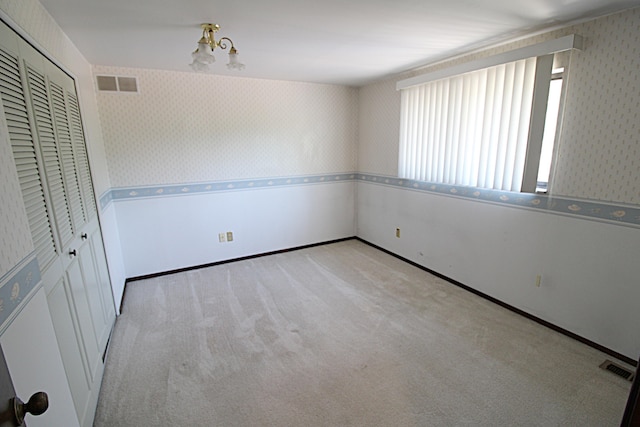 48501 E Ranch Dr, Chesterfield Twp, MI 48051 - unfurnished bedroom featuring wallpapered walls, carpet flooring, and a closet