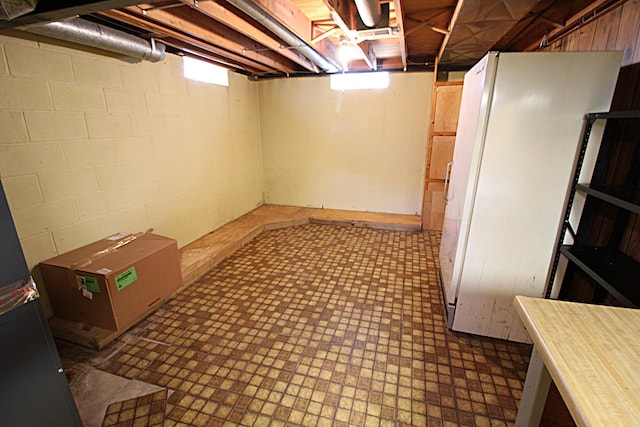 48501 E Ranch Dr, Chesterfield Twp, MI 48051 - basement with tile patterned floors and freestanding refrigerator