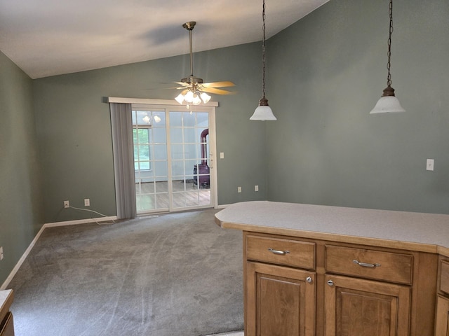 10505 N Athey Ave, Harrison, MI 48625 - kitchen featuring vaulted ceiling, light colored carpet, brown cabinets, ceiling fan, and hanging light fixtures