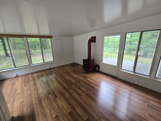 10505 N Athey Ave, Harrison, MI 48625 - unfurnished living room with a wood stove and wood finished floors