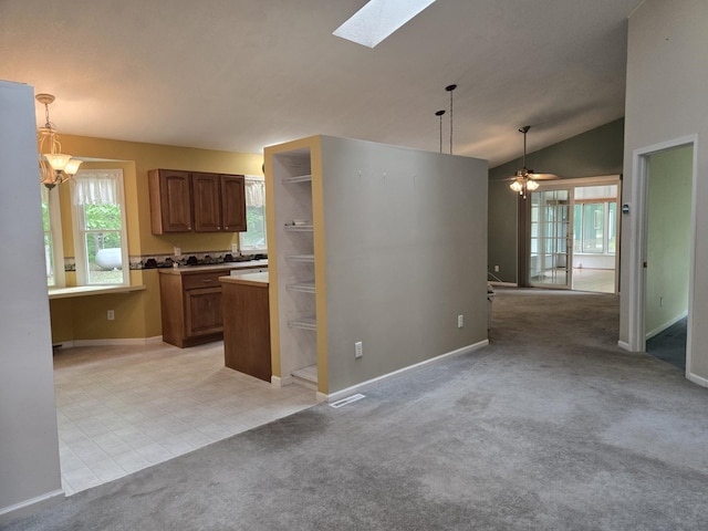 10505 N Athey Ave, Harrison, MI 48625 - kitchen featuring a skylight, ceiling fan, hanging light fixtures, light colored carpet, and lofted ceiling