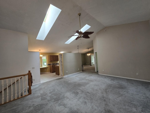 10505 N Athey Ave, Harrison, MI 48625 - unfurnished living room featuring a skylight, light colored carpet, ceiling fan, a chandelier, and high vaulted ceiling