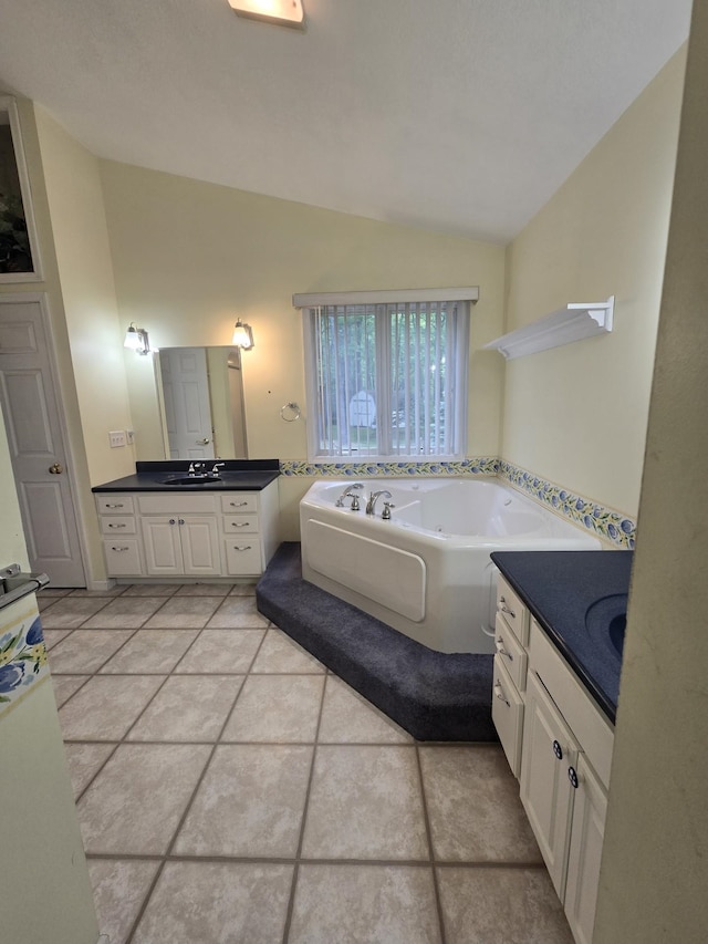 10505 N Athey Ave, Harrison, MI 48625 - bathroom with vaulted ceiling, two vanities, a jetted tub, and tile patterned flooring
