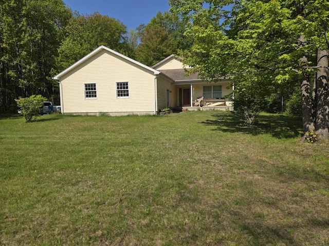 10505 N Athey Ave, Harrison, MI 48625 - view of side of home with a lawn and covered porch