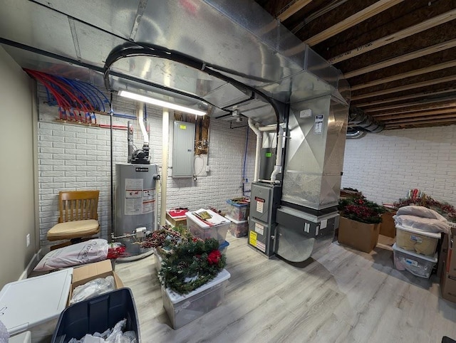5953 Qwinn Ct, Bay City, MI 48706 - unfinished basement with gas water heater, electric panel, brick wall, light wood-style floors, and heating unit