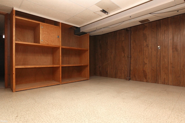 31717 Tecla St, Warren, MI 48088 - finished below grade area featuring wooden walls, tile patterned floors, and a drop ceiling